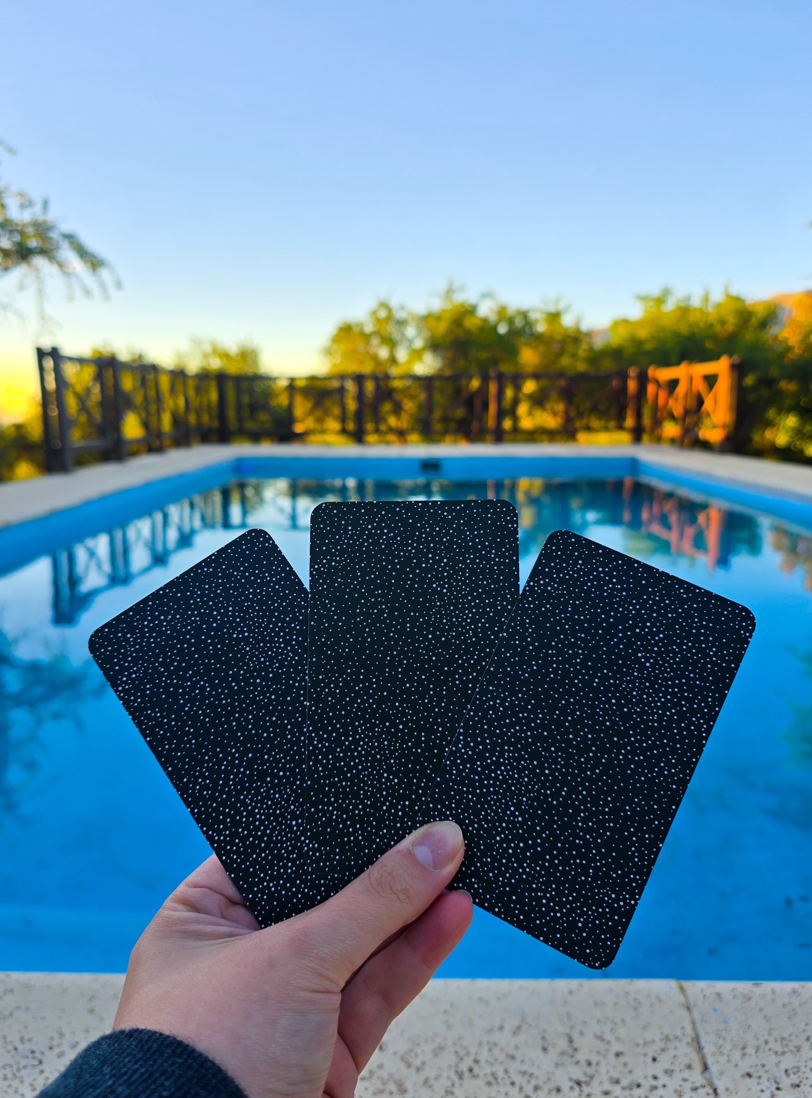 Tres cartas estrelladas frente a una pileta al amanecer